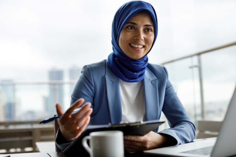 a woman talking to someone using her hands and holding a clipboard