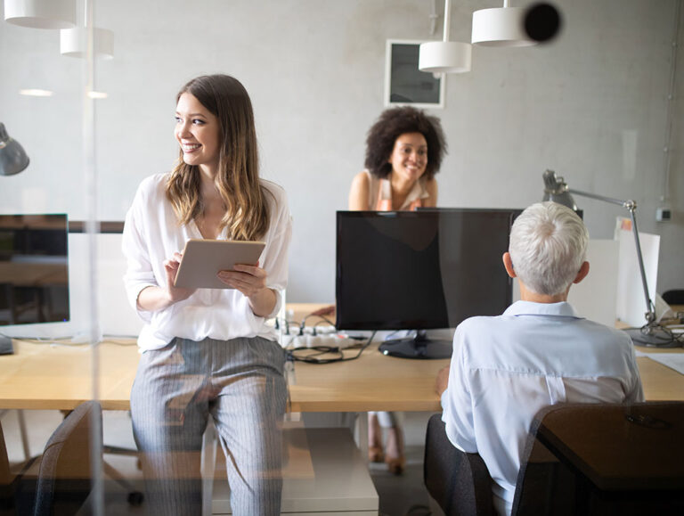 three female professionals in office space