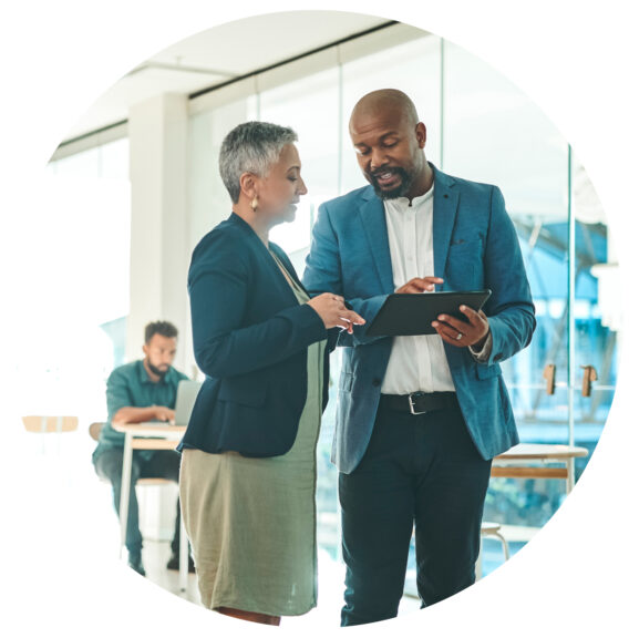 man and woman discussing business deal looking at tablet